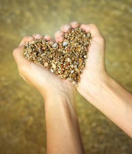 Heart symbol in feminine hand. Conceptual design.